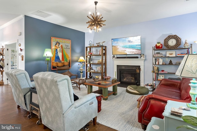 23593 Robalo Rd, Frankford, DE 19945 - living room with wood finished floors, a glass covered fireplace, a chandelier, and ornamental molding