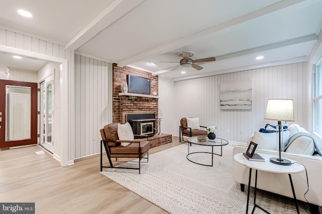 6488 Davis Ford Rd, Manassas, VA 20111 - living room with wood finished floors, beam ceiling, ceiling fan, baseboards, and a wood stove