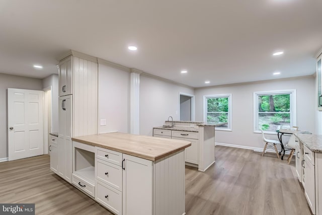 6488 Davis Ford Rd, Manassas, VA 20111 - kitchen with wood counters, light wood-type flooring, a sink, a peninsula, and recessed lighting