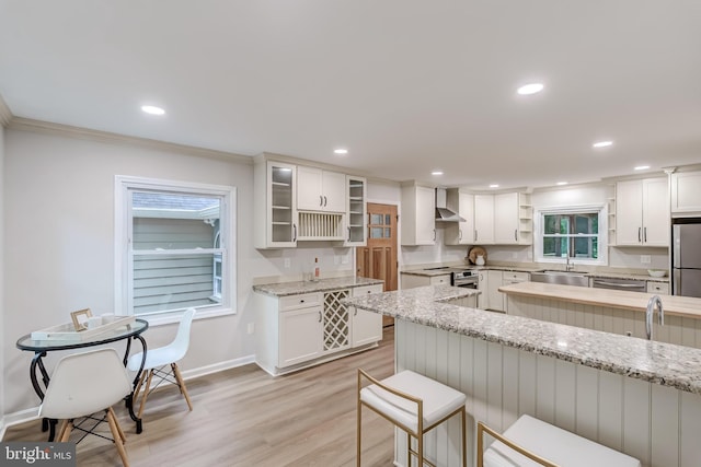 6488 Davis Ford Rd, Manassas, VA 20111 - kitchen featuring open shelves, wall chimney range hood, stainless steel appliances, a sink, and baseboards