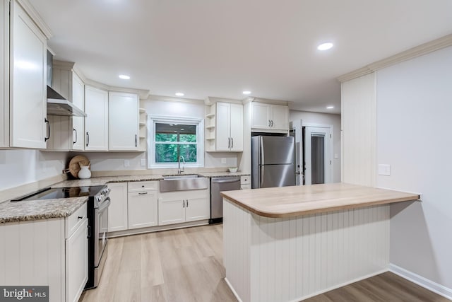 6488 Davis Ford Rd, Manassas, VA 20111 - kitchen with appliances with stainless steel finishes, a sink, open shelves, light wood-style flooring, and white cabinets