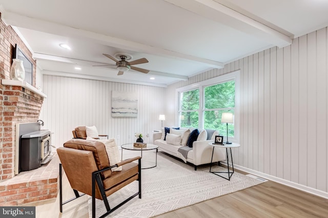 6488 Davis Ford Rd, Manassas, VA 20111 - living room with light wood finished floors, beam ceiling, ceiling fan, and a wood stove