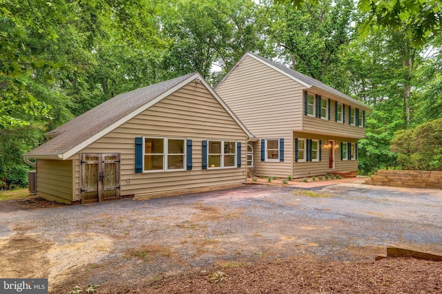 6488 Davis Ford Rd, Manassas, VA 20111 - view of front facade with a shingled roof and central air condition unit