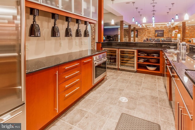 bar with a dry bar, light tile patterned flooring, pendant lighting, beverage cooler, and appliances with stainless steel finishes