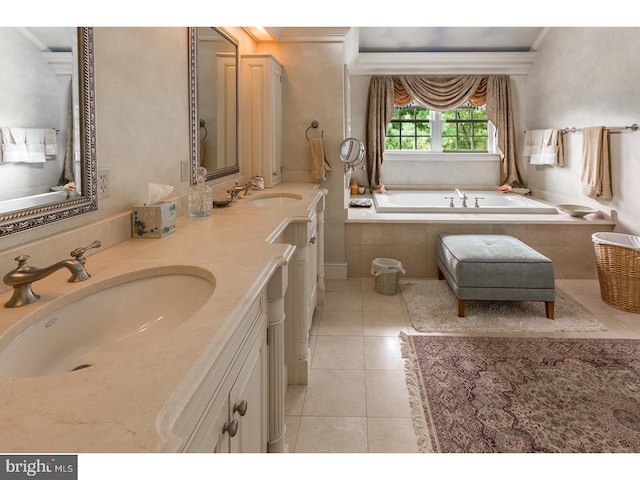 bathroom with a sink, tile patterned flooring, double vanity, and a bath