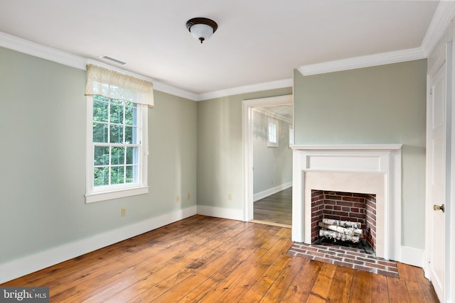 unfurnished living room featuring baseboards, crown molding, wood-type flooring, and visible vents