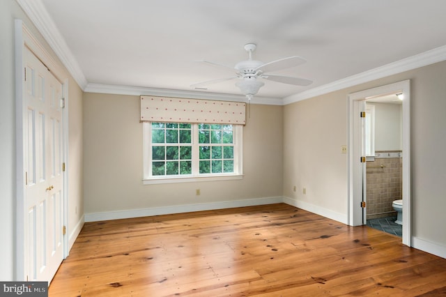 unfurnished bedroom with crown molding, baseboards, and hardwood / wood-style floors