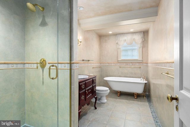 bathroom with tile walls, a shower stall, tile patterned floors, vanity, and a freestanding tub