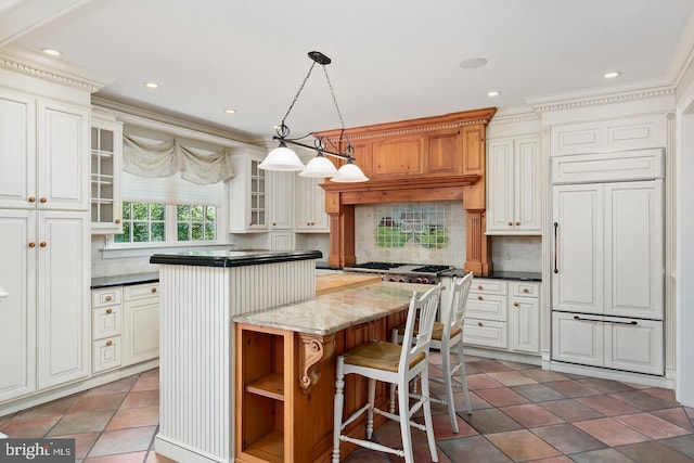 kitchen featuring recessed lighting, hanging light fixtures, tile patterned floors, a kitchen island, and backsplash