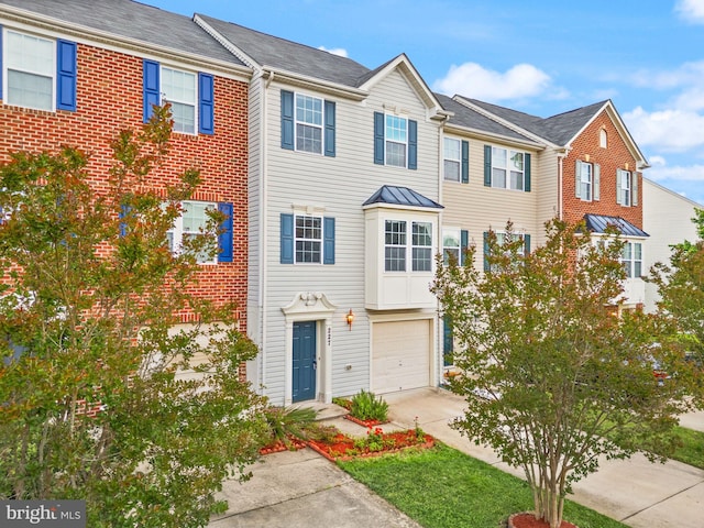 townhome / multi-family property with concrete driveway and an attached garage