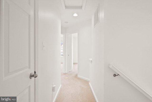 hallway featuring light carpet, baseboards, an upstairs landing, recessed lighting, and attic access