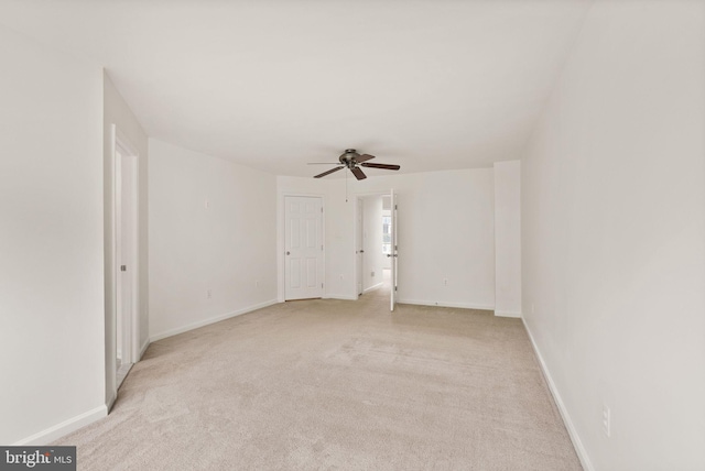unfurnished room with ceiling fan, light carpet, and baseboards