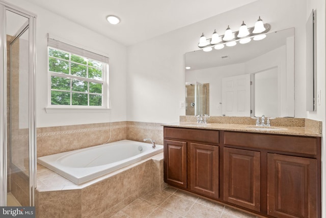 full bath featuring a shower stall, a bath, double vanity, and tile patterned flooring