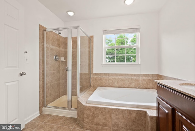 bathroom featuring a stall shower, a bath, tile patterned flooring, and vanity