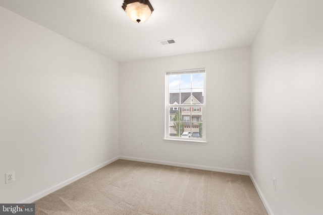 unfurnished room with carpet flooring and baseboards