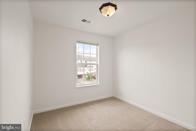 carpeted spare room with baseboards