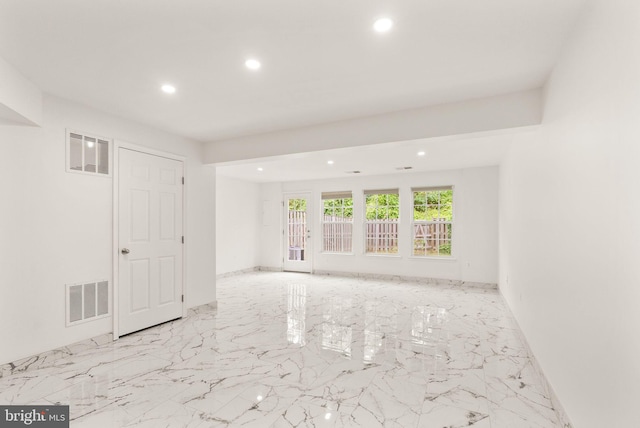 spare room with recessed lighting, baseboards, and marble tiled flooring