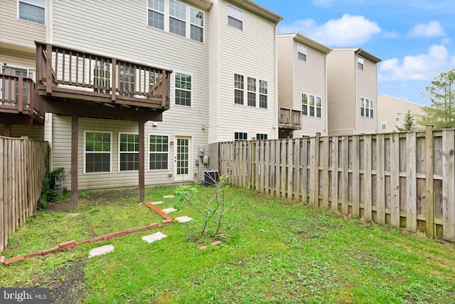 back of house featuring a wooden deck and central AC unit