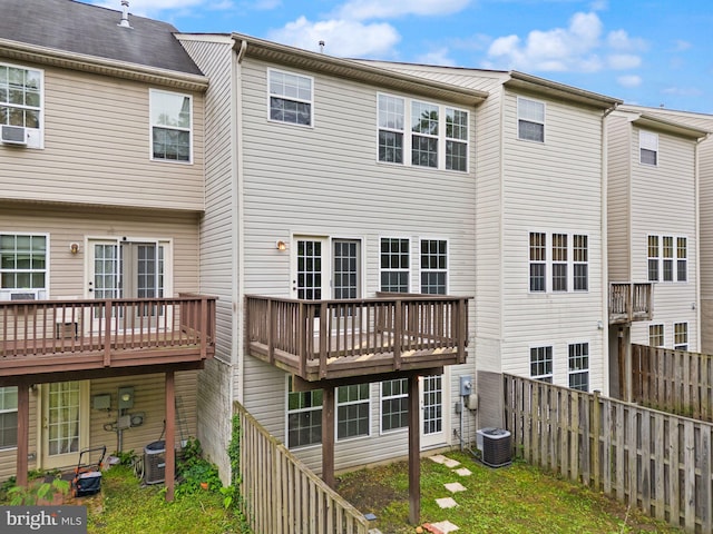 rear view of property featuring cooling unit and a fenced backyard