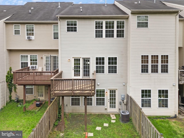 back of property with central AC unit and a deck