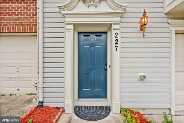 view of exterior entry featuring a garage