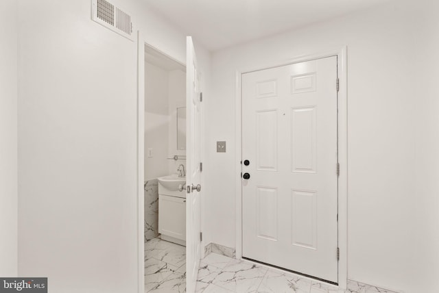 entryway featuring light marble finish flooring