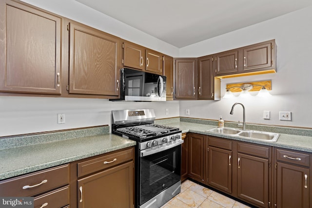 1307 Morling Ave, Baltimore, MD 21211 - kitchen featuring stainless steel appliances, a sink, light tile patterned floors, and light countertops
