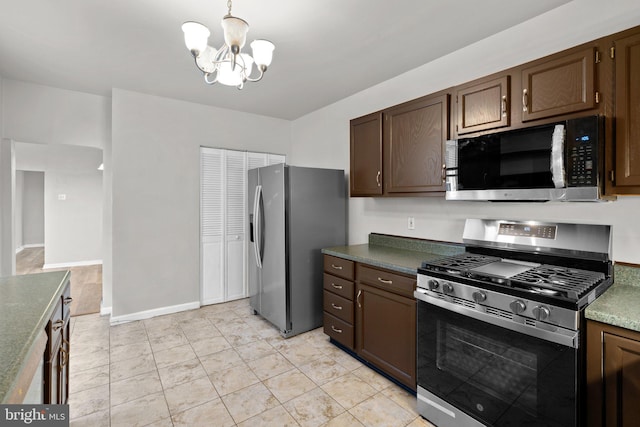 1307 Morling Ave, Baltimore, MD 21211 - kitchen featuring stainless steel appliances, a chandelier, dark brown cabinetry, decorative light fixtures, and dark countertops