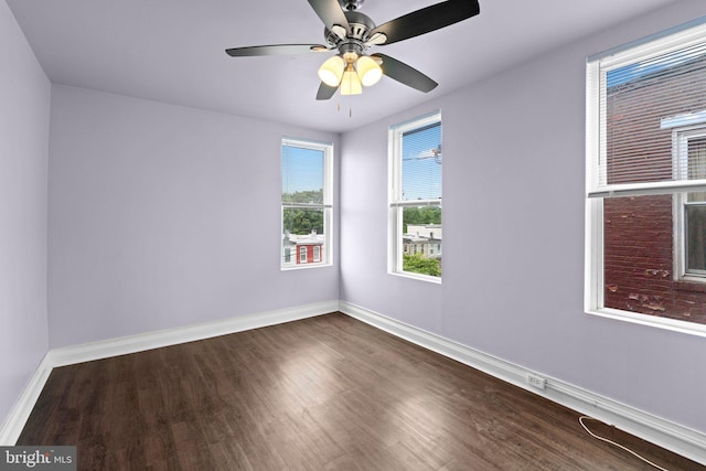 1307 Morling Ave, Baltimore, MD 21211 - unfurnished room featuring dark wood-type flooring, baseboards, and a ceiling fan