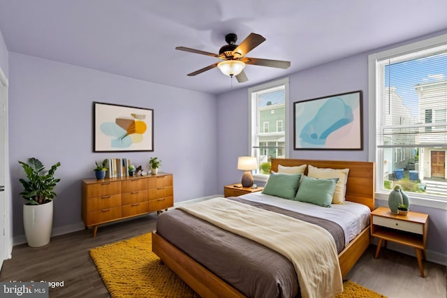 1307 Morling Ave, Baltimore, MD 21211 - bedroom featuring multiple windows, wood finished floors, and baseboards