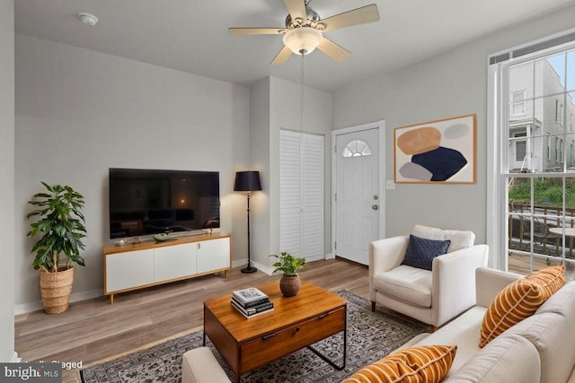1307 Morling Ave, Baltimore, MD 21211 - living room with wood finished floors, a ceiling fan, and baseboards