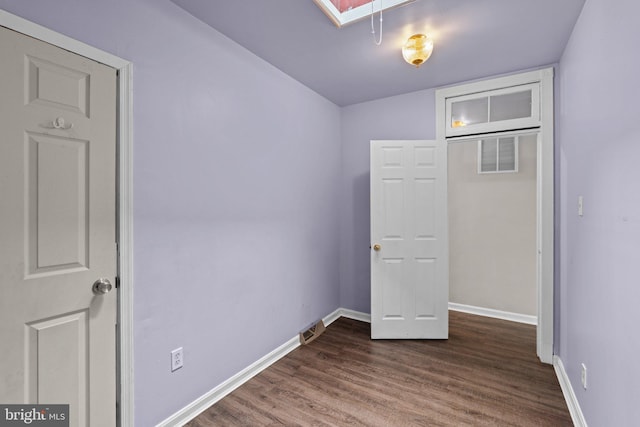 1307 Morling Ave, Baltimore, MD 21211 - unfurnished bedroom featuring dark wood-style flooring, baseboards, and a skylight