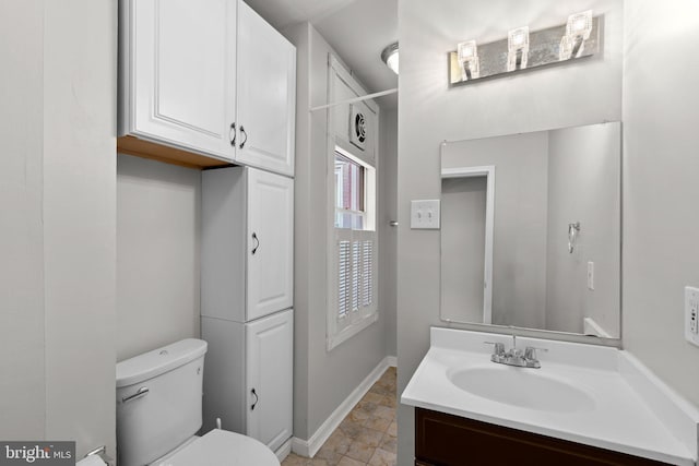 1307 Morling Ave, Baltimore, MD 21211 - bathroom with vanity, toilet, and baseboards