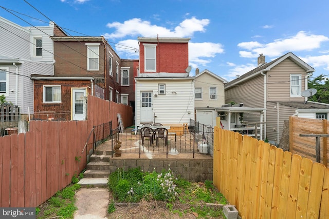 1307 Morling Ave, Baltimore, MD 21211 - back of house with a fenced backyard and a patio area