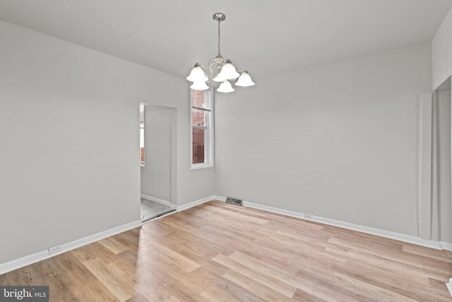 1307 Morling Ave, Baltimore, MD 21211 - unfurnished room with a chandelier, light wood-type flooring, and baseboards
