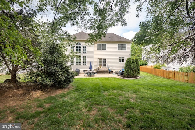 back of house with a yard, a patio area, fence, and entry steps