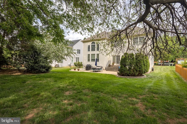 back of house with a patio area, fence, a lawn, and entry steps