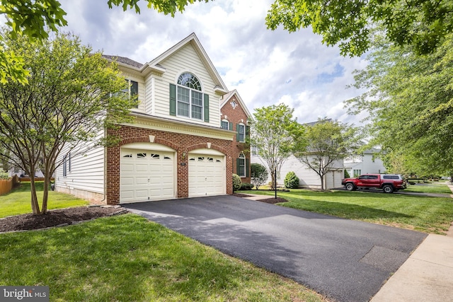 view of front facade with a front lawn, driveway, brick siding, and a garage