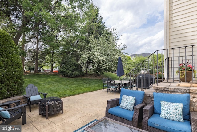 view of patio featuring an outdoor fire pit and stairs