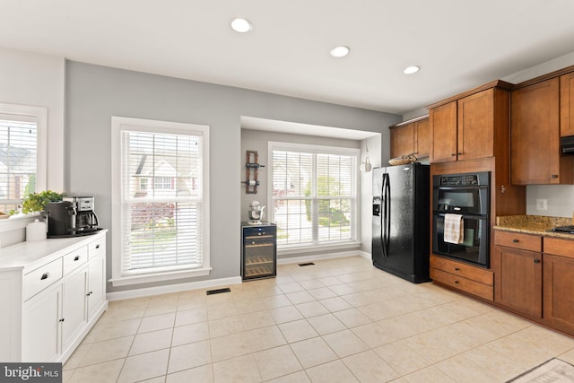 kitchen with black appliances, baseboards, recessed lighting, brown cabinetry, and beverage cooler