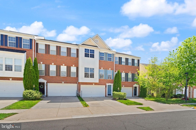 multi unit property with driveway, brick siding, and a garage