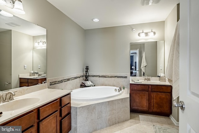 bathroom featuring two vanities, a garden tub, and tile patterned flooring