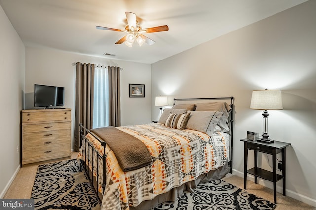 bedroom featuring baseboards, light colored carpet, and a ceiling fan