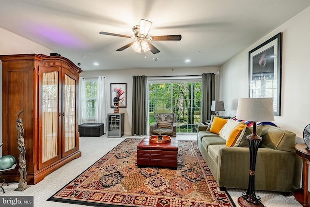 carpeted living area with a ceiling fan and recessed lighting