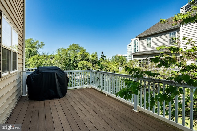 wooden terrace with a grill