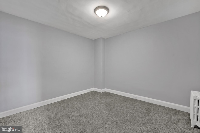 carpeted empty room with baseboards