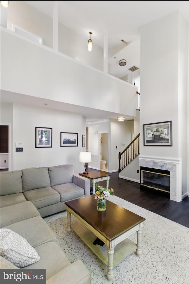 43253 Katie Leigh Ct, Ashburn, VA 20147 - living room featuring a high ceiling, stairway, wood finished floors, and baseboards