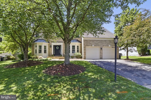 43253 Katie Leigh Ct, Ashburn, VA 20147 - view of front facade with asphalt driveway, an attached garage, a front lawn, and a standing seam roof