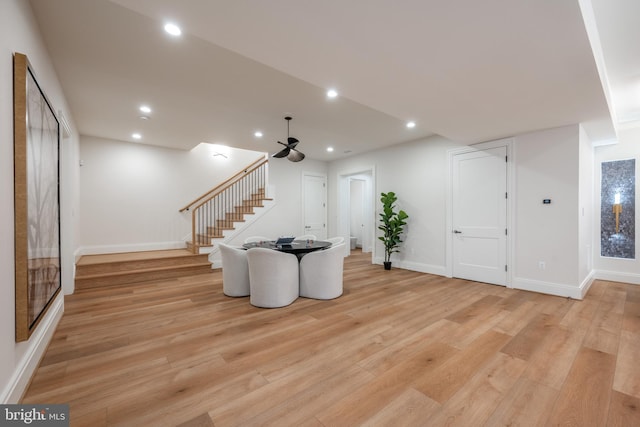 living room with stairway, light wood-style flooring, baseboards, and recessed lighting