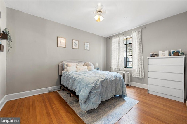 1305 Broom St Unit 105, Wilmington, DE 19806 - bedroom with radiator, baseboards, and wood finished floors